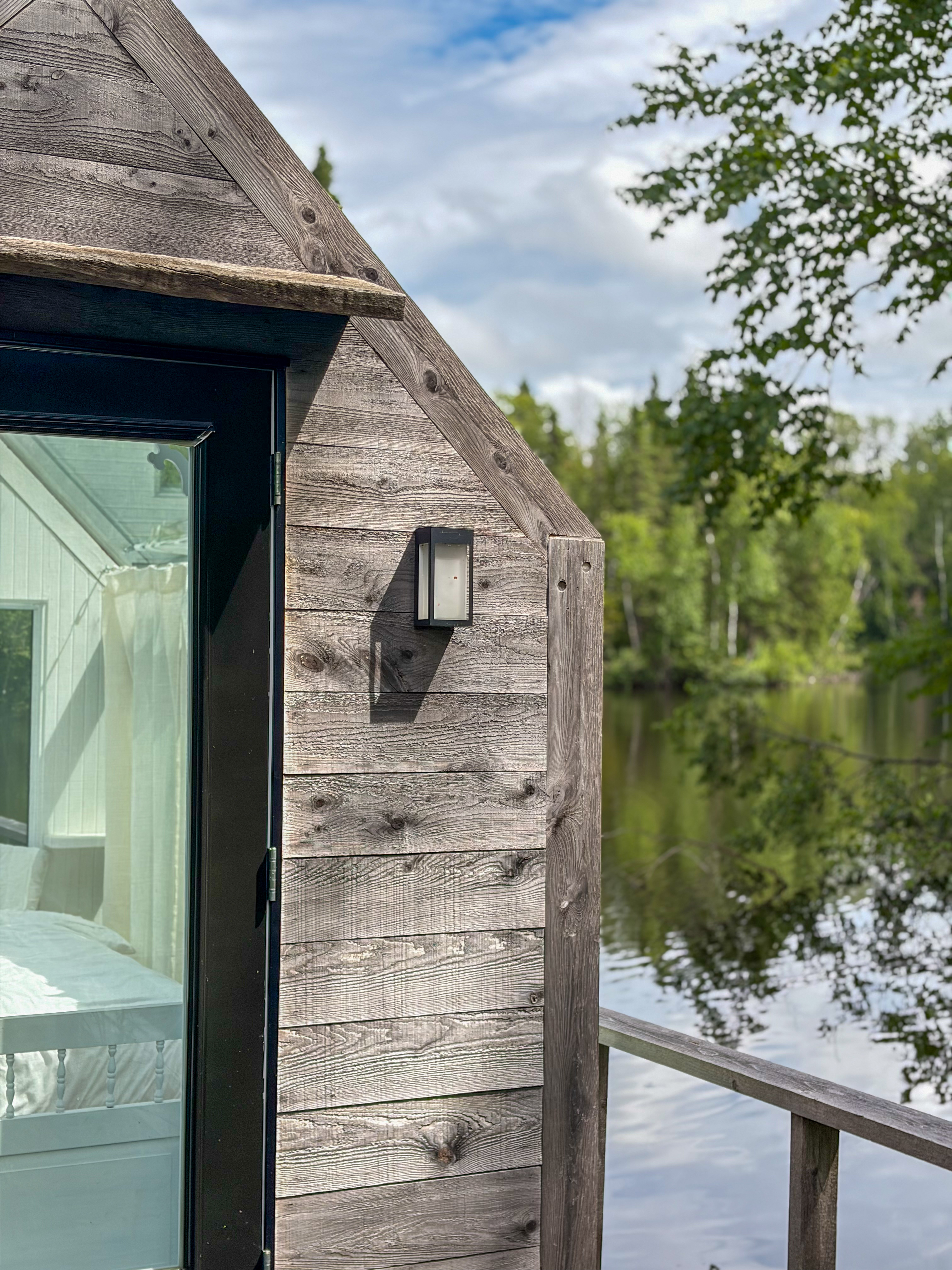 The exterior of La Maison de Verre at the water's edge